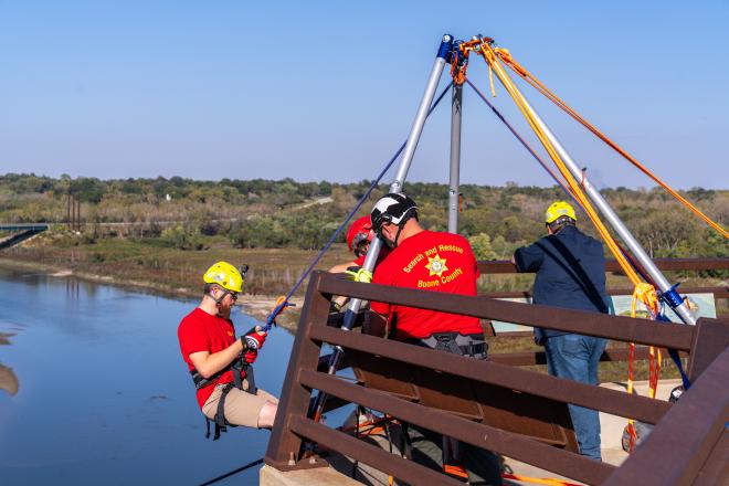 Rescuer going over the side of the bridge